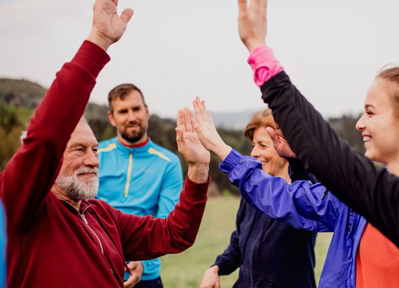 group of people high-fiving outside